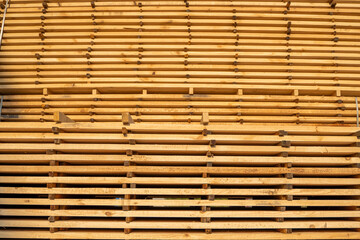 Storage of piles of wooden boards on the sawmill. Boards are stacked in a carpentry shop. Sawing drying and marketing of wood. Pine lumber for furniture production, construction. Lumber Industry.