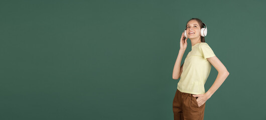 Caucasian young woman's portrait isolated over green studio background with copyspace