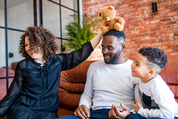 Happy family with one kid playing at home