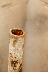 rusty water pipe after thirty years of operation. Corrosion inside a pipe. Water filter. Replacement of water supply. Repair in a bathroom. Old pipes of communications. Need to clean a tap water