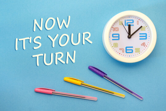 NOW IT'S YOUR TURN - lettering on a blue background and clock