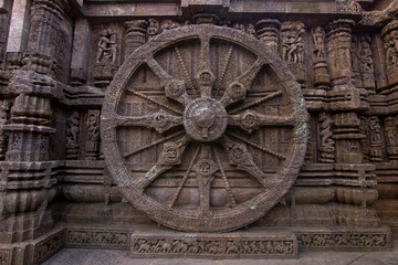 Fototapeta na wymiar A chariot wheel carved into the wall of the 13th century Konark Sun Temple, Odisha, India.