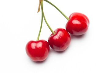Small red cherries on a white background