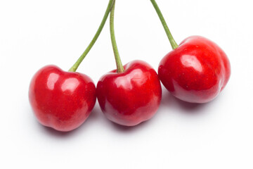Small red cherries on a white background