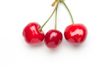 Small red cherries on a white background