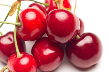 Small red cherries on a white background