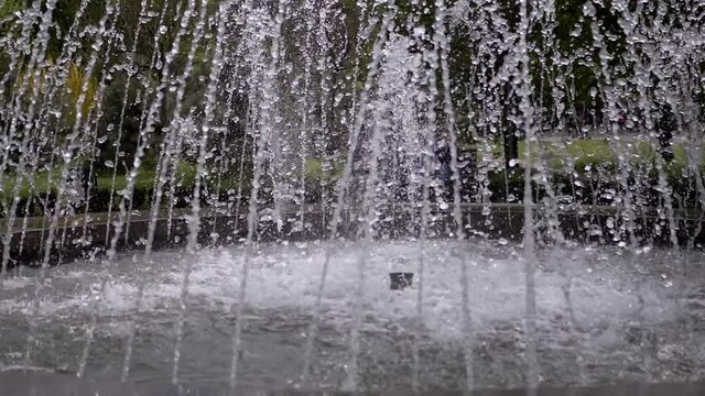 Water Jets from City Fountain in the Park. Water head and pressure. Water drops fall in the bowl of fountain. Splashes of water. Slow motion. Close up. 180 fps.