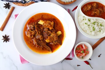 Shahi Mutton curry, Mutton masala, Mutton korma is a famous Spicy non-vegetarian dish of India. It's made out of Goat meat along with spices. Served with rice and roti. copy space.