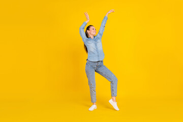 Full length body size photo young pretty girl dancing at party in jeans clothes isolated bright yellow color background