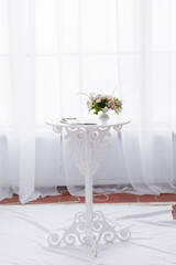 White carved round table for wedding ceremony. Elegant coffee table