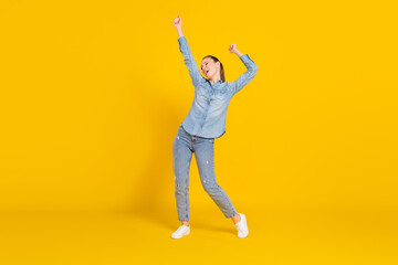 Fototapeta na wymiar Full length body size photo smiling girl laughing dancing at party overjoyed isolated vivid yellow color background