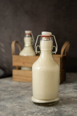 Organic milk bottle on dark background, retro vintage styled glass milk bottle, diary product