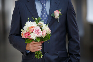 Wedding bouquet in Groom's hands