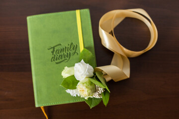 Family diary book and little bouquet of flowers