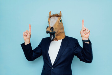 Man with horse mask points up.