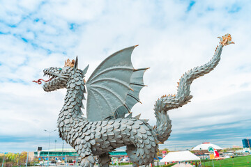 Fototapeta premium Dragon sculpture on the background of a mosque in Kazan, Russia