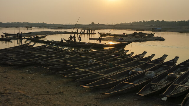 Beautiful sunset panorama with wooden boats on Goyain river, Jaflong, Sylhet division, Bangladesh