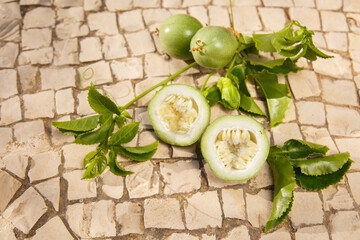 Green Passiflora fruit. Passion fruit on stone surface