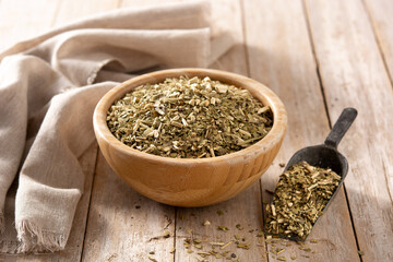 Traditional yerba mate tea in bowl on wooden table. typical Argentine drink