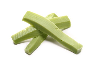 Green spicy cheese slices with wasabi flavor isolated on white background