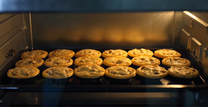 Mini Pie From Meat And Mushrooms Baking In Industrial Oven