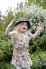Active little toddler girl running and jumping in the park © triocean