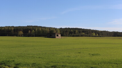 Fototapeta premium abandoned army casemetas in green field