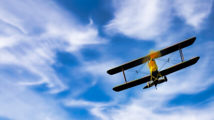 Vintage double wing biplane airplane banking into a bright blue sky with white puffy clouds.  Aviation illustration. Room for copy text © Bob Orsillo