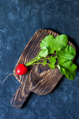 Fresh organic radish from farm on rustic board