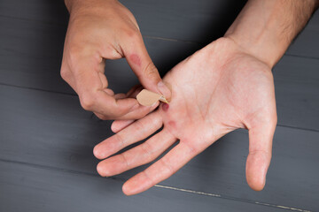 a man glues a patch on the corn