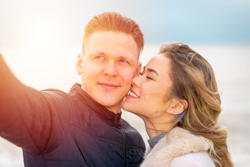 Happy romantic Smiling couple taking selfie on the sunny beach