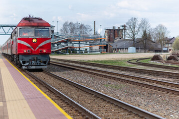 Railroad tracks and red locomotive in the town.old train locomotive.