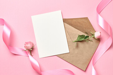 Greeting card with envelope, pink ribbon and rose flower, mockup with copy space