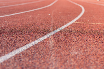 Part Red plastic track in the outdoor track and field stadium.Close-up.
