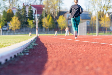 Woman running treadmill of a stadium around. Activity for weight loss and a healthy lifestyle.Selective focus.