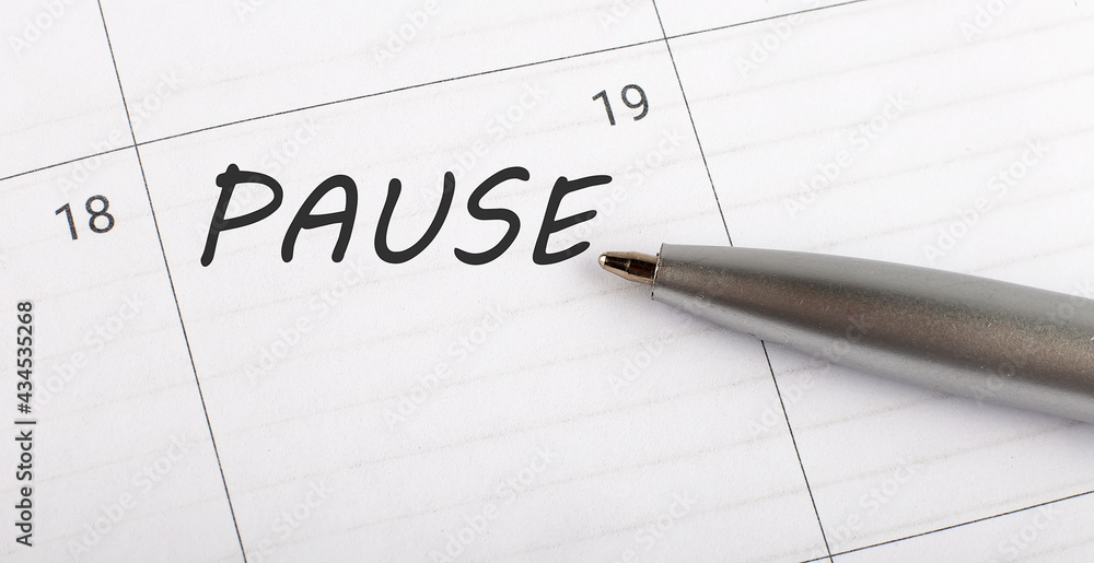 Poster text pause on calendar planner to remind you an important appointment with a pen on isolated white b