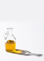 Olive oil  bottle on  white background with hard light and shadow.Copy space