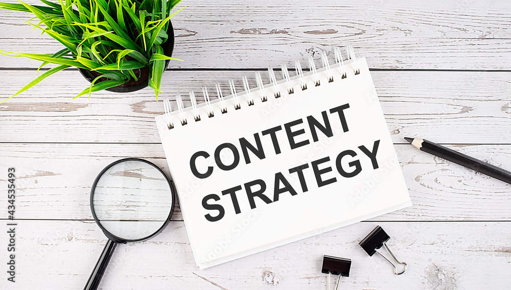 Aufkleber content strategy text concept write on notebook with office tools on the wooden background