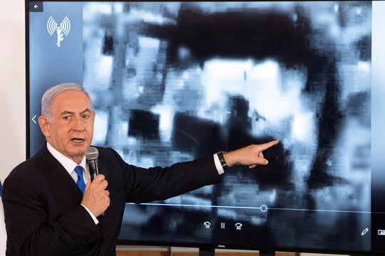 Israeli Prime Minister Netanyahu gestures as he shows a slideshow during a briefing to ambassadors to Israel at a military base in Tel Aviv