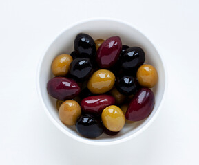 Different kinds of organic ripe olives on oil close up