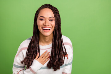 Photo of attractive nice dark skin young woman laugh good mood joke isolated on green color...
