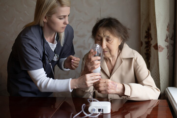 Young Female Doctor Holding Oxygen Mask Over Senior woman Patient's Face