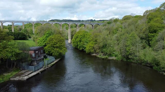 Aerial view Pontcysyllte aqueduct and River Dee canal narrow boat bride in Chirk Welsh valley countryside zoom in low angle