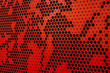 Red metallic background with perforation of round holes