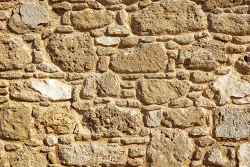 Stone wall texture background, ancient Greek house in Paphos, Cyprus