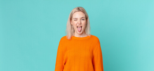blond pretty woman with cheerful and rebellious attitude, joking and sticking tongue out