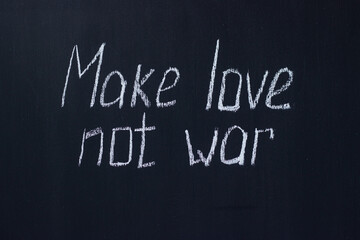 Obraz premium Chalkboard text Make love not war. Life-affirming and pacifist lettering