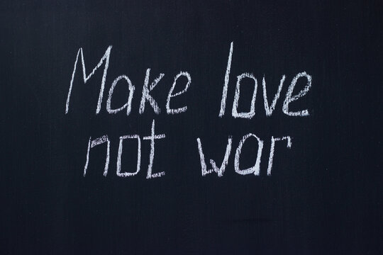 
Chalkboard text Make love not war. Life-affirming and pacifist lettering