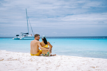 couple of men and woman mid age on the beach of Curacao, Grote Knip beach Curacao Dutch Antilles...