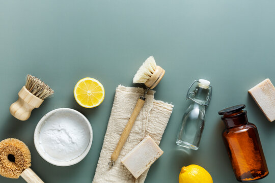 Zero waste Eco friendly cleaning concept, baking soda, wooden brushes, vinegar, lemon, salt, soap. Top view, flat lay. Copy space.